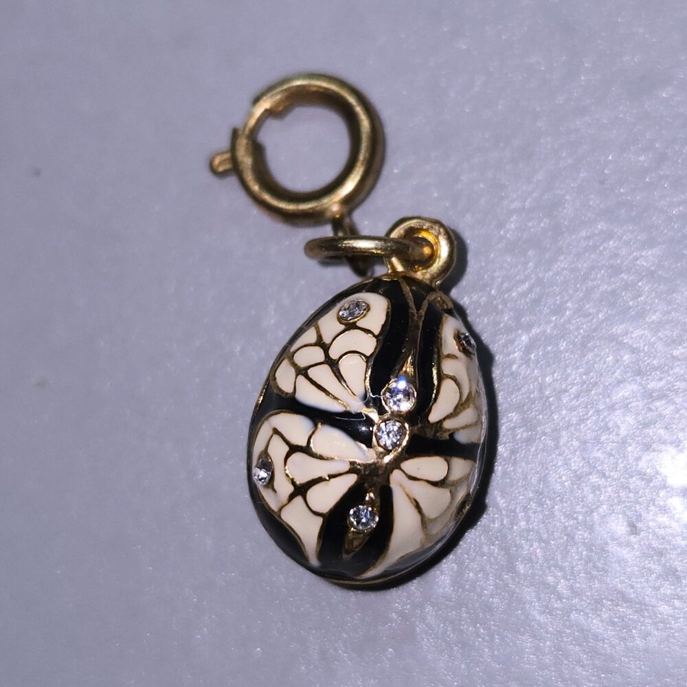 Blue enamel egg charm pendant with white enamel moth/butterfly